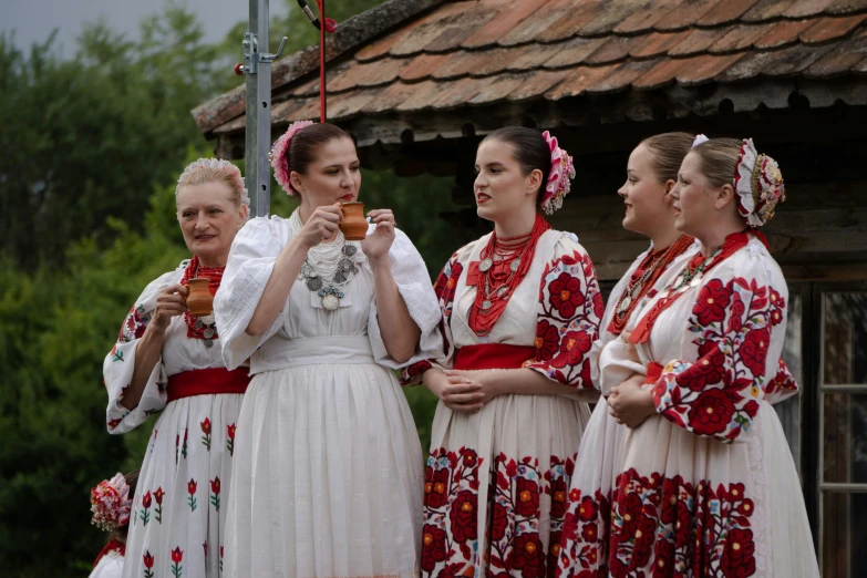 four woman are dressed in different ethnic style dresses