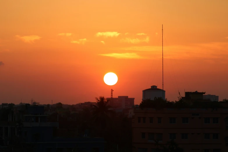 the sun is setting in a clear orange sky