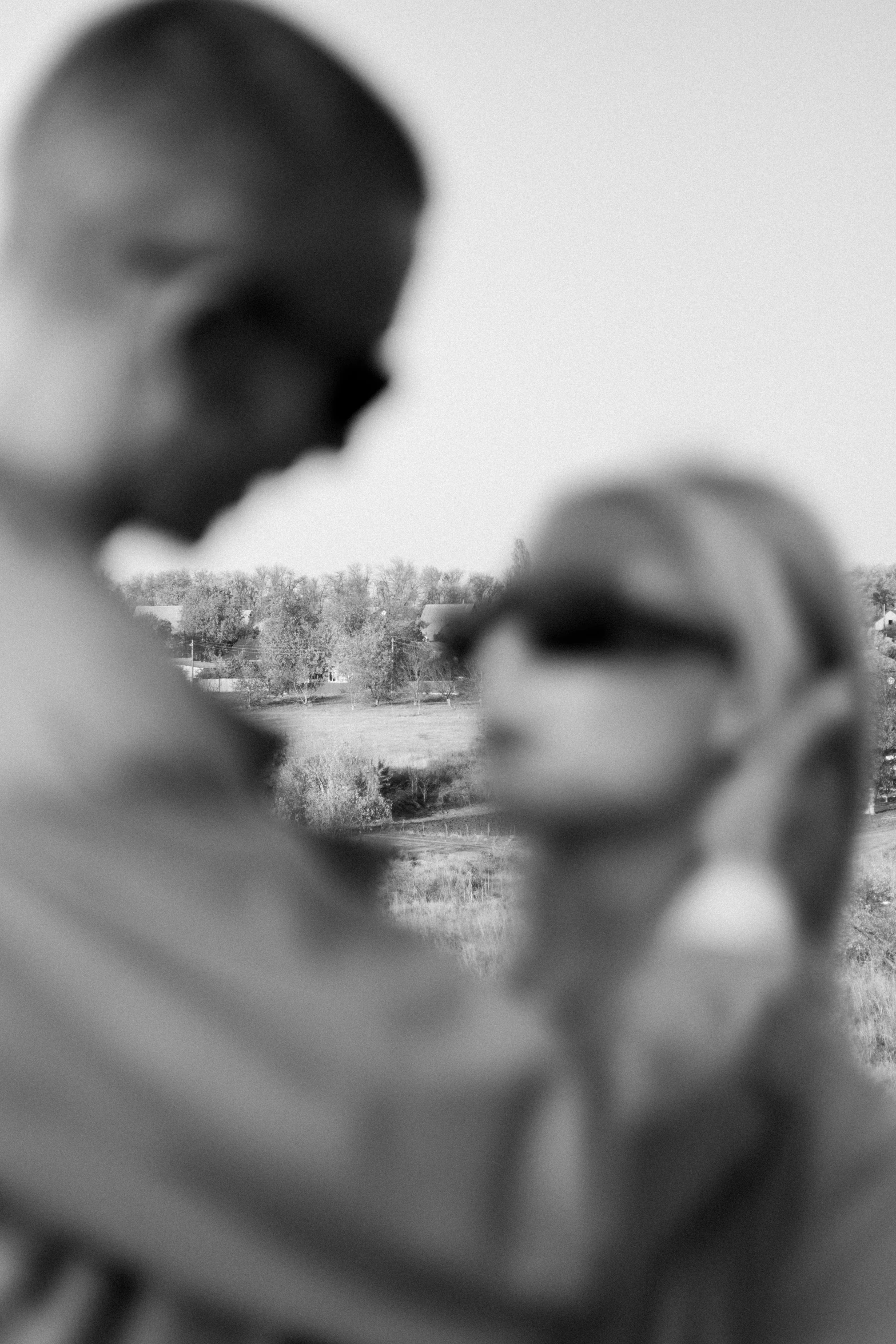 a man and woman standing in an open field