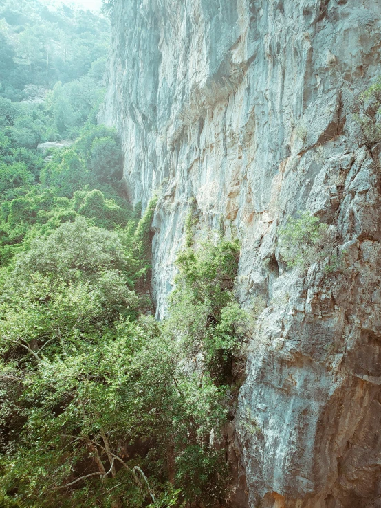 a man is climbing up a steep slope