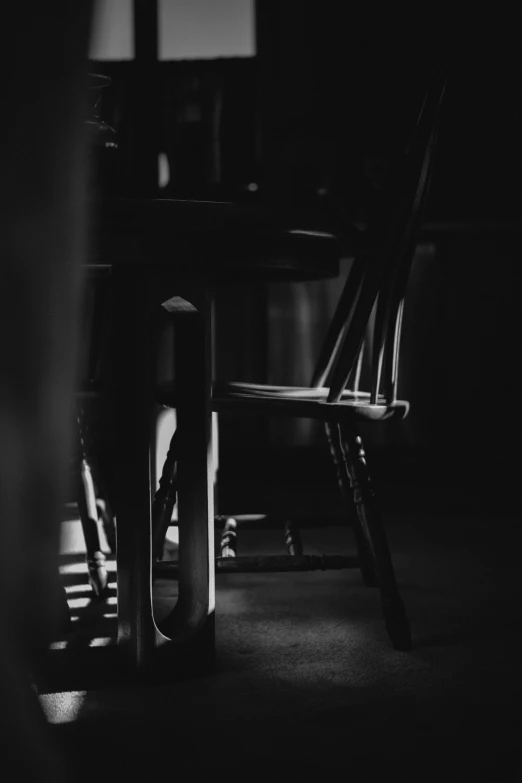 chairs and a desk sit in a dark room