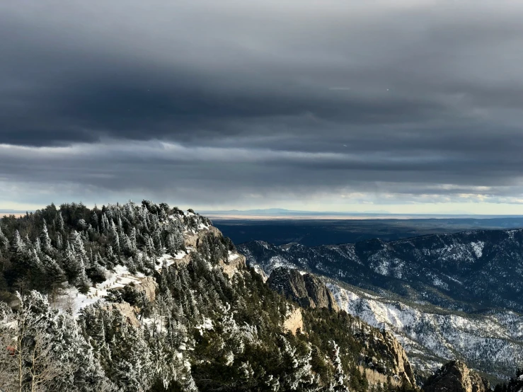 a cloudy sky with the mountains in the background