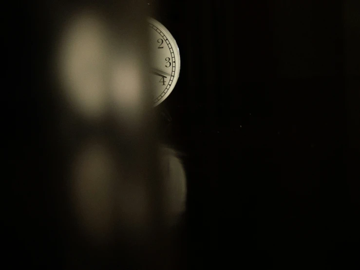 the back of an old clock, lit in the dark