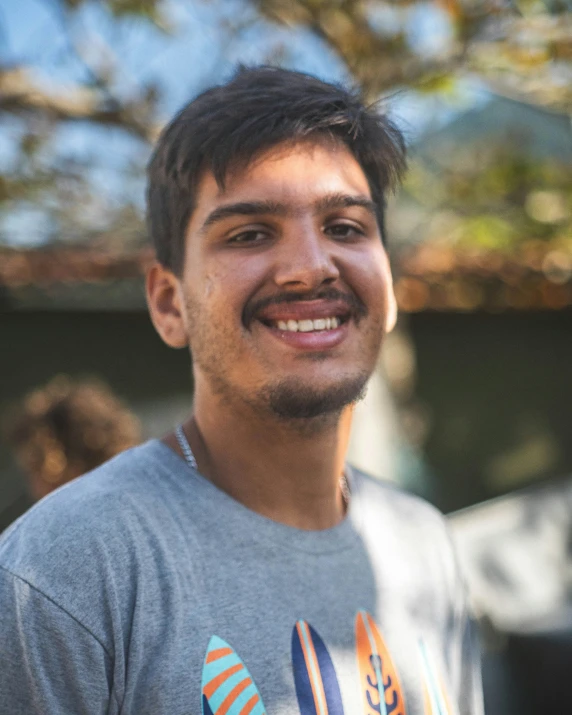 a close up s of a smiling man with a tie on