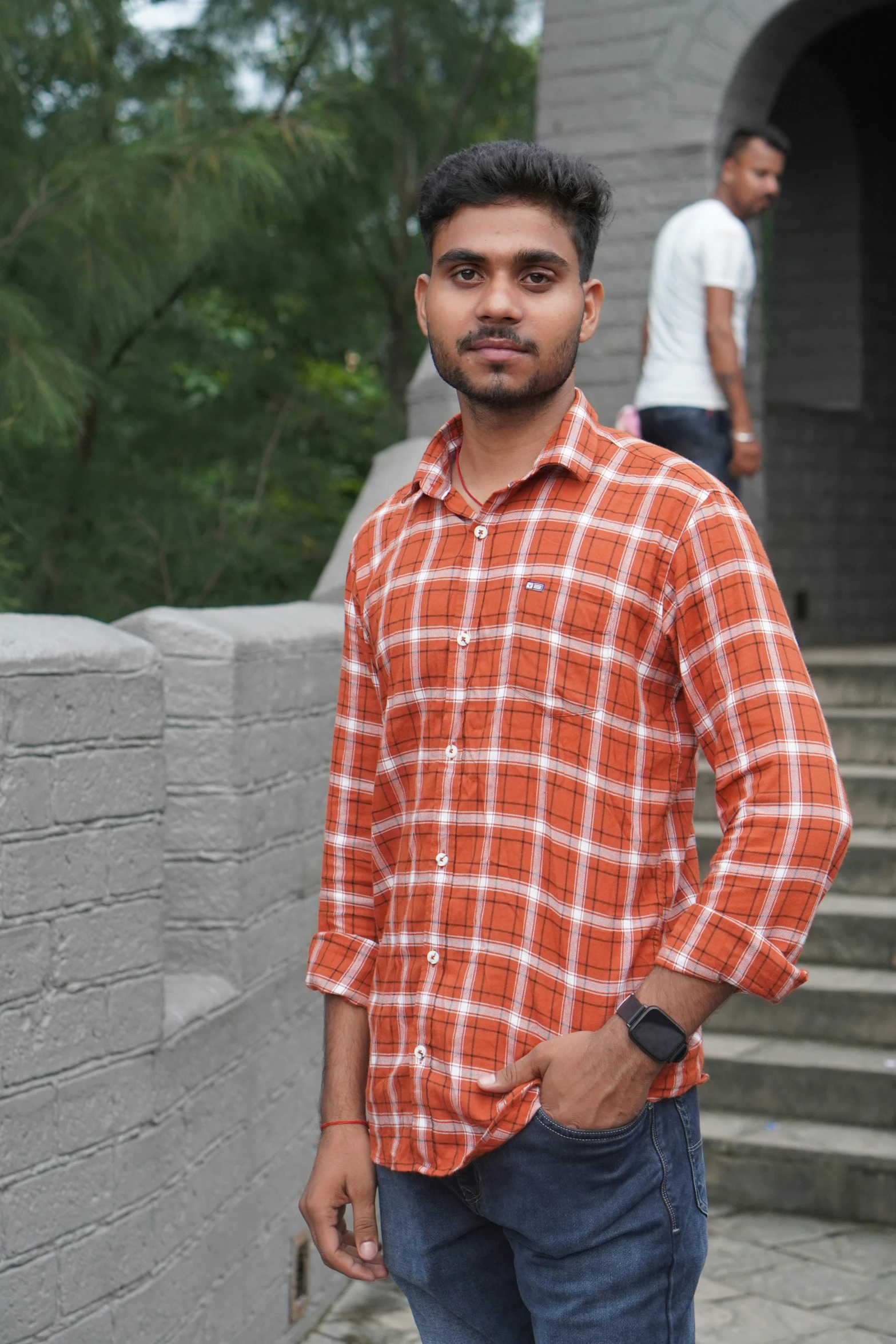 a man standing in front of a brick building