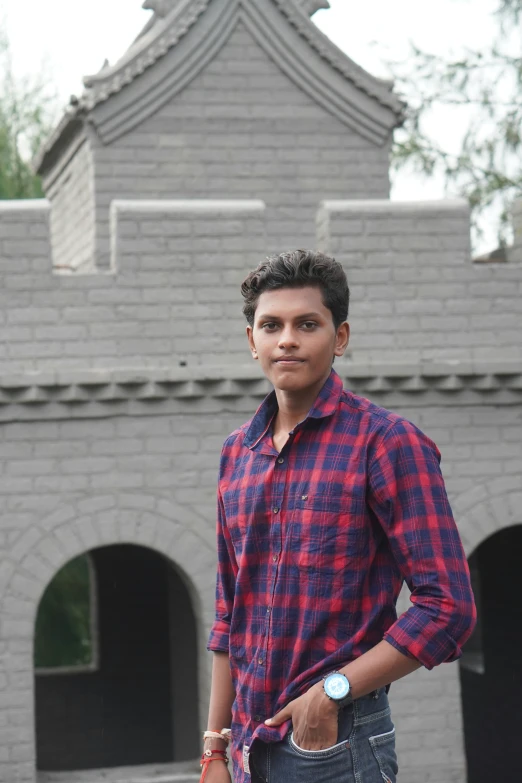 a young man is posing for a picture with his hand in his pocket