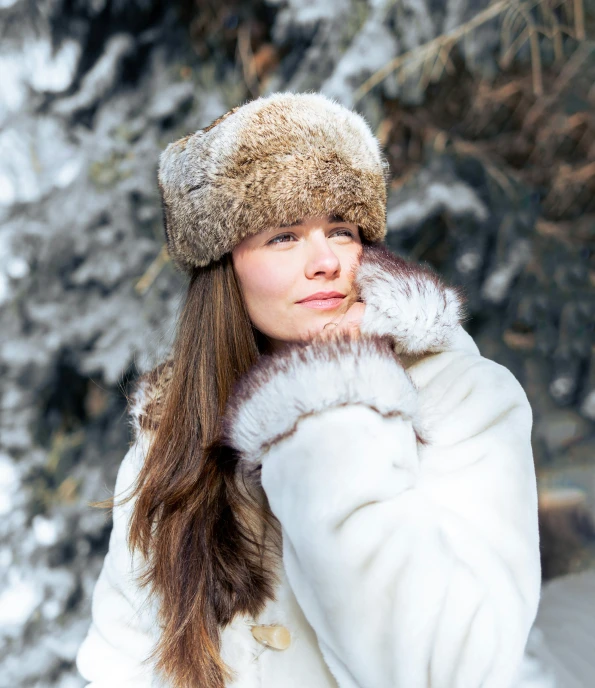 a woman in white is outside in the snow