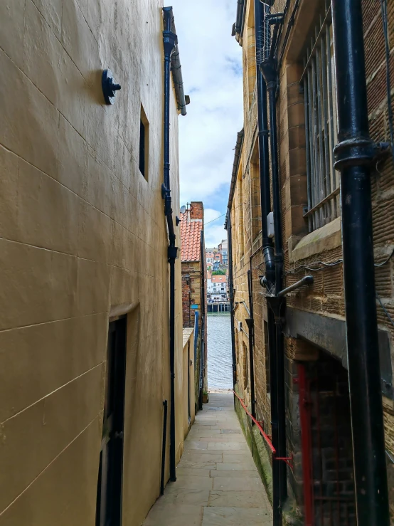 a long walkway between two buildings and some water