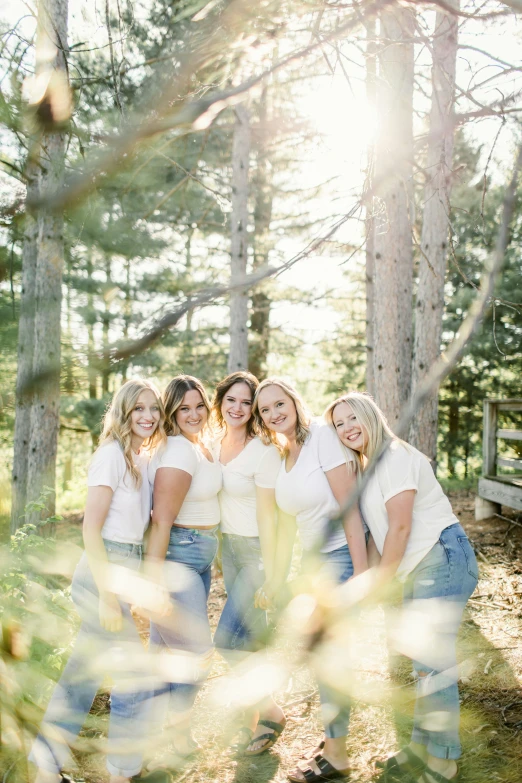 a group of women standing in a forest