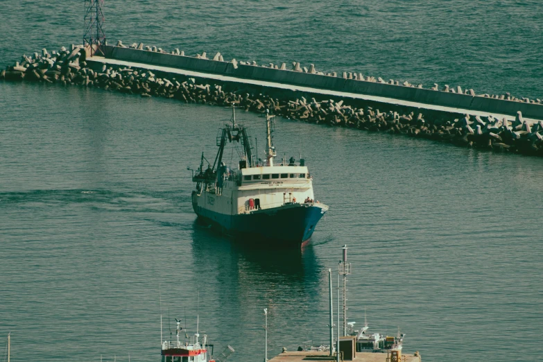 a big ship in the water near a dock