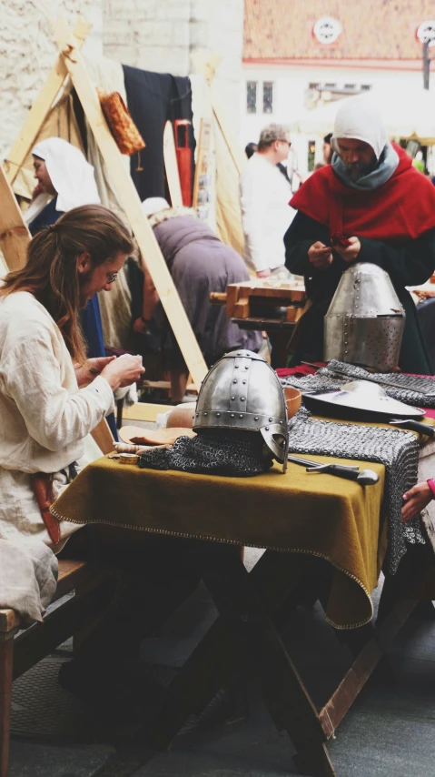 several women with helmets sitting at an outdoor table