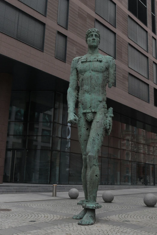 statue of a man outside a tall building