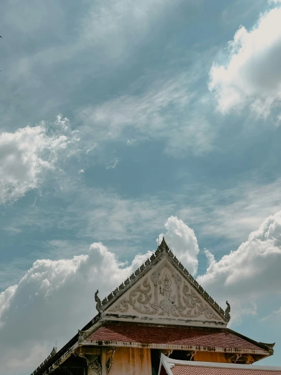 an airplane flying over a brick building in the sky