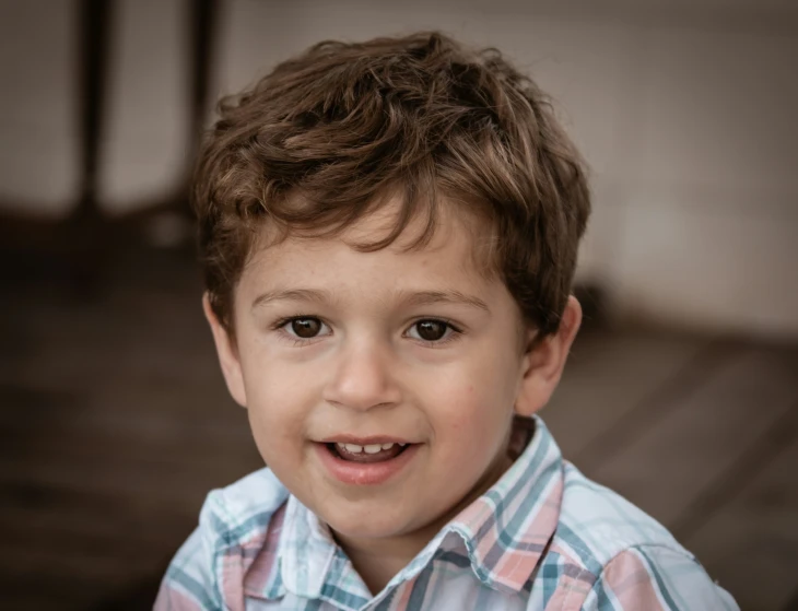 a close up of a child smiling for the camera