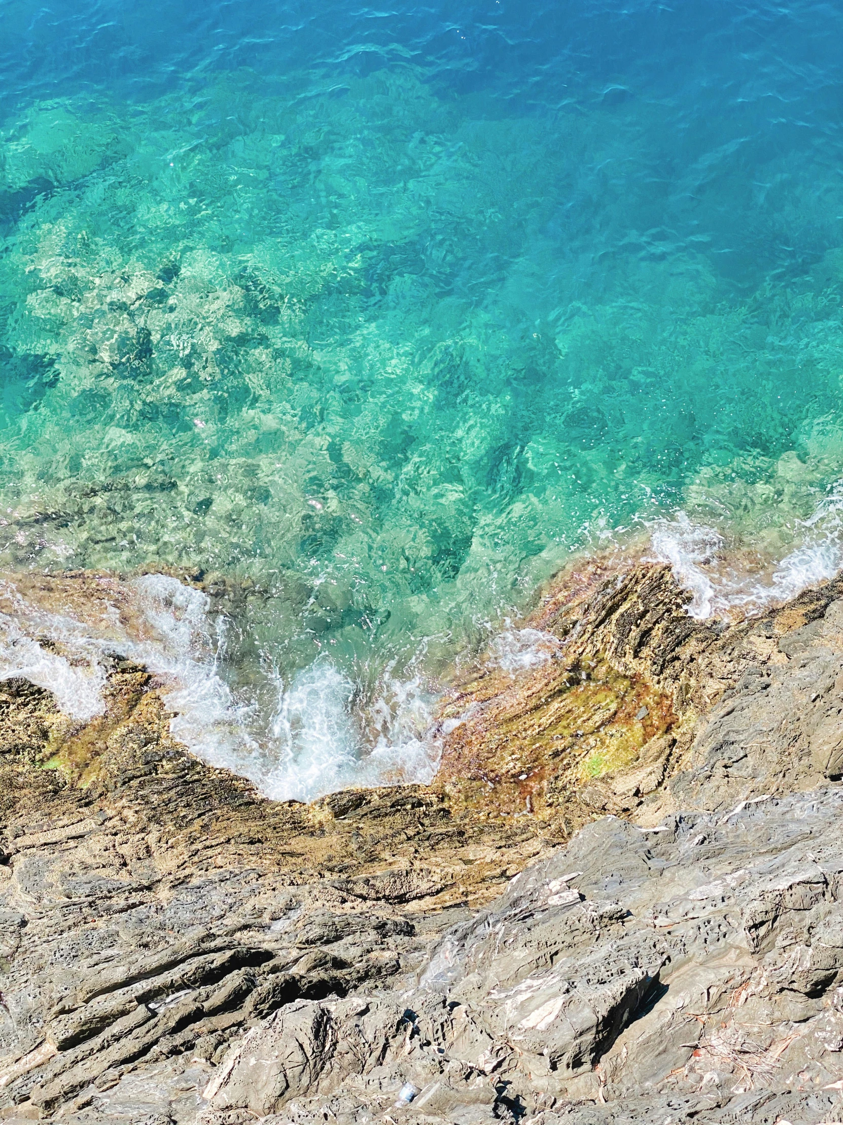 a po taken from the top of a mountain to a view of the ocean and rocks