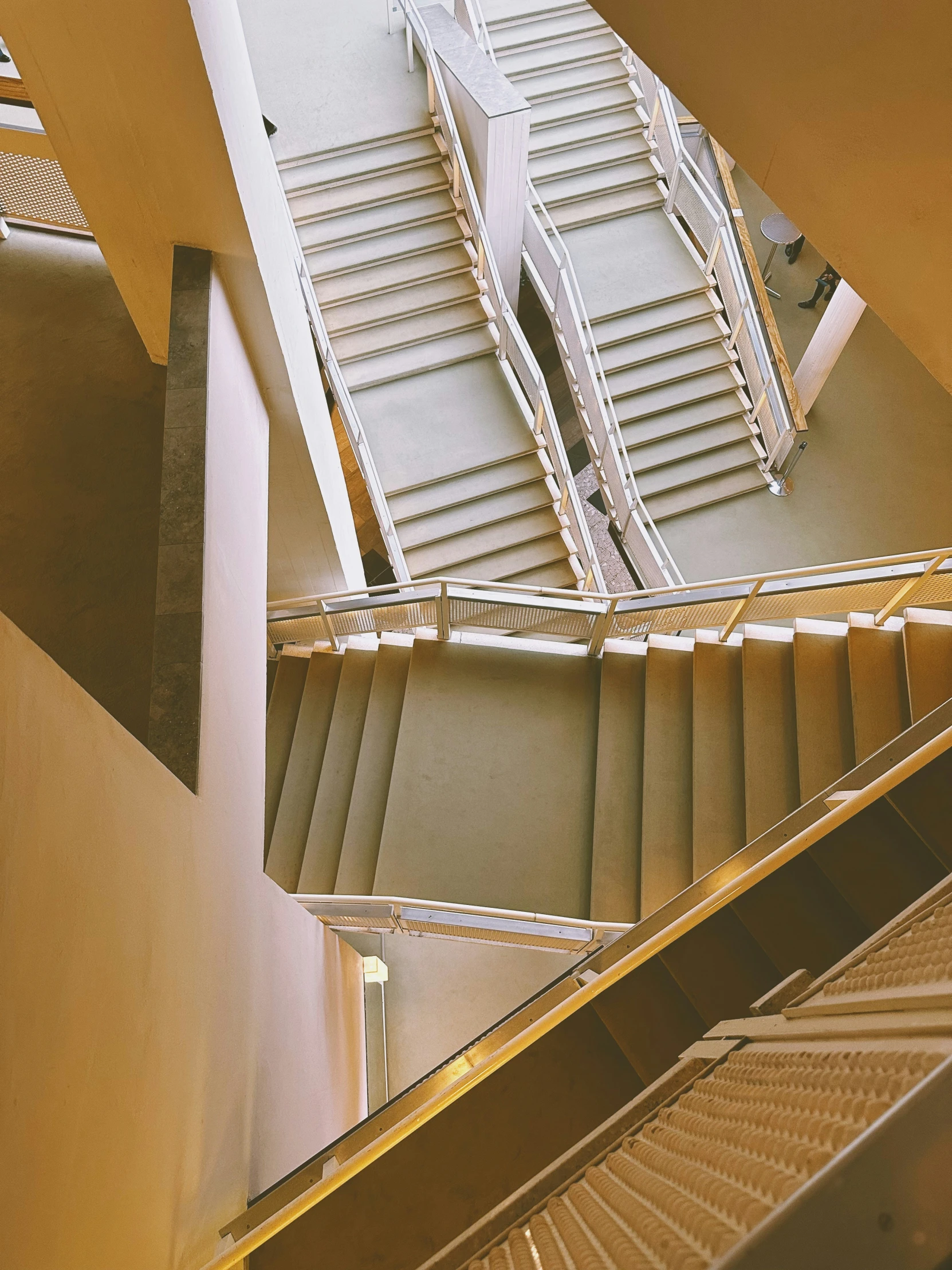 the stairwell leads up to a large building