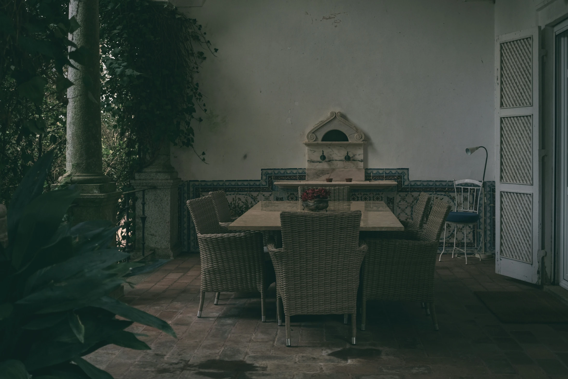 a table surrounded by wicker chairs and other furniture