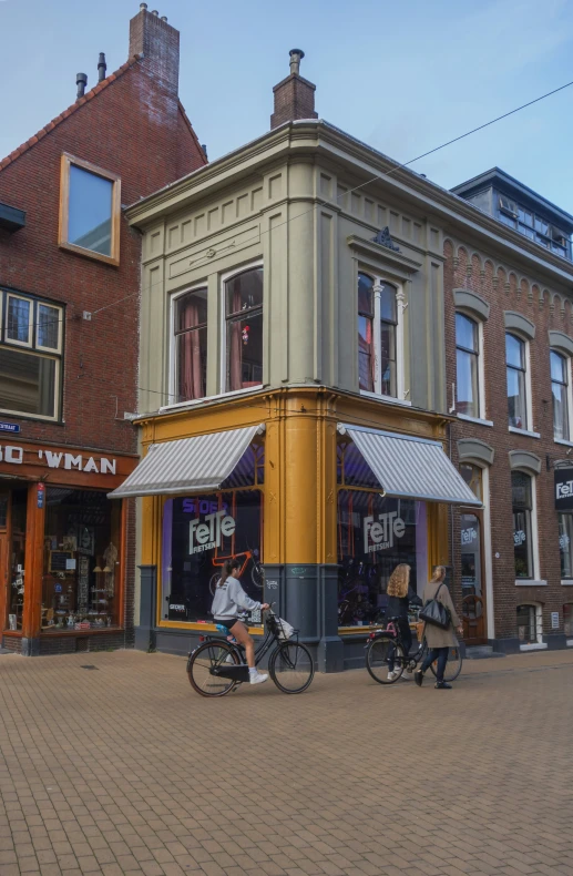 three people sitting on bikes on a street