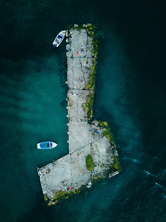 two boats are docked on a pier