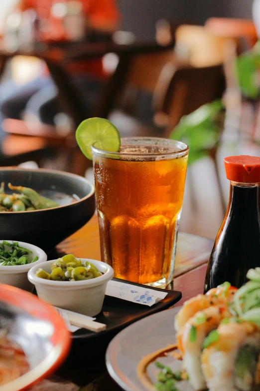 a person is sitting at a table full of plates of food