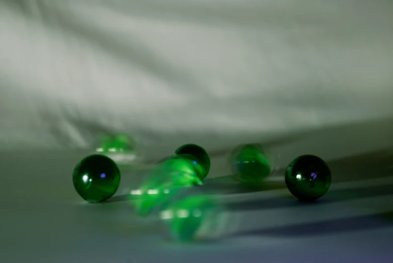 three green marbles are on the table