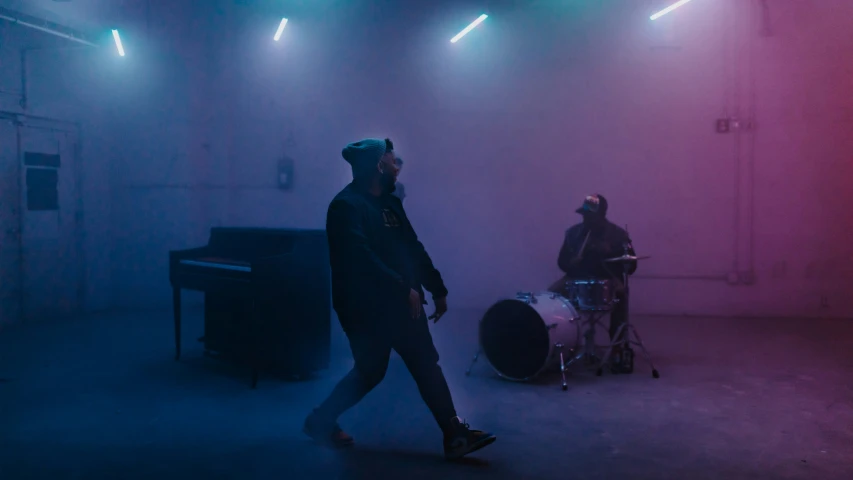 two people are playing a music band in a dark room