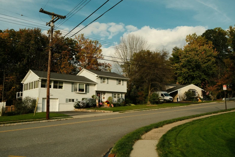 a small town street with houses next to it