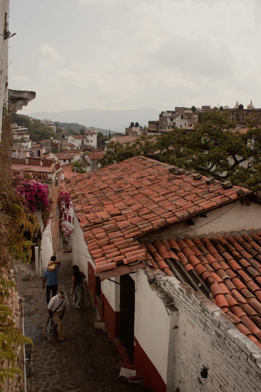 people walking up and down a street with buildings