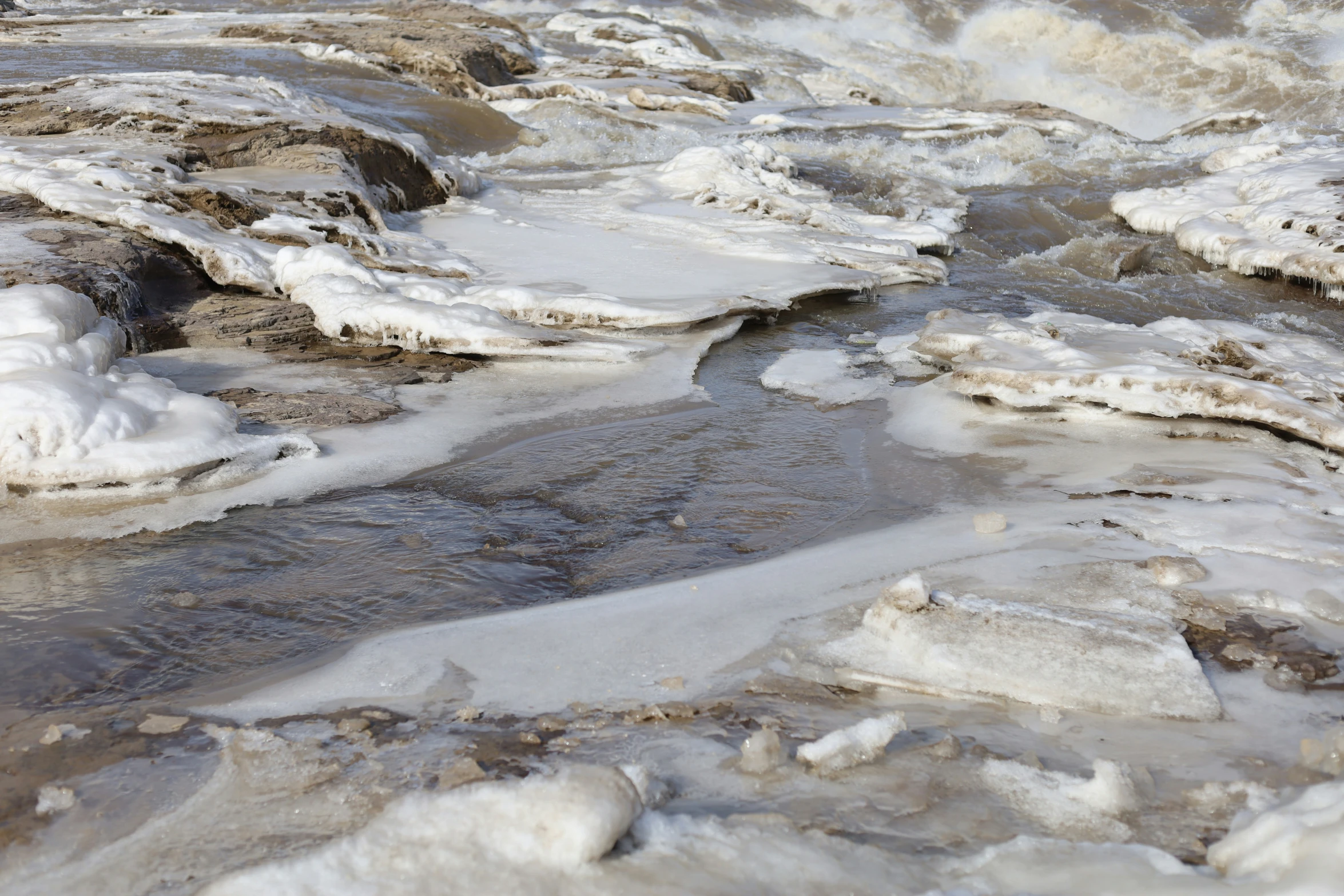 several layers of ice and water with lots of snow