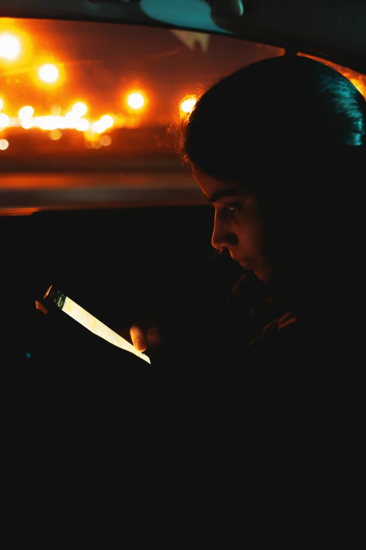 the back side of a car as a woman sits in a taxi