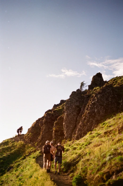 people walking on the steep mountain trail