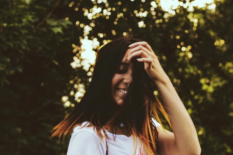 a woman that is standing near a tree