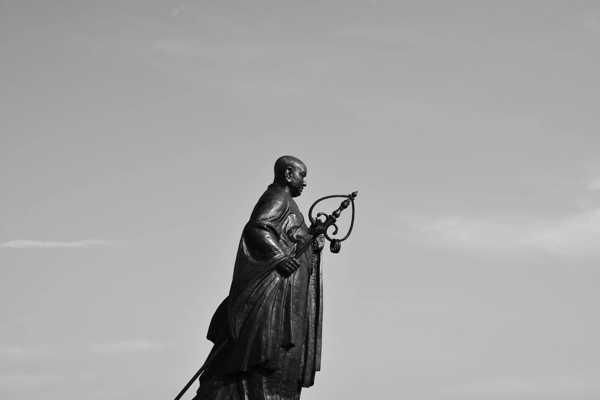 a statue of a person with tennis rackets on their legs