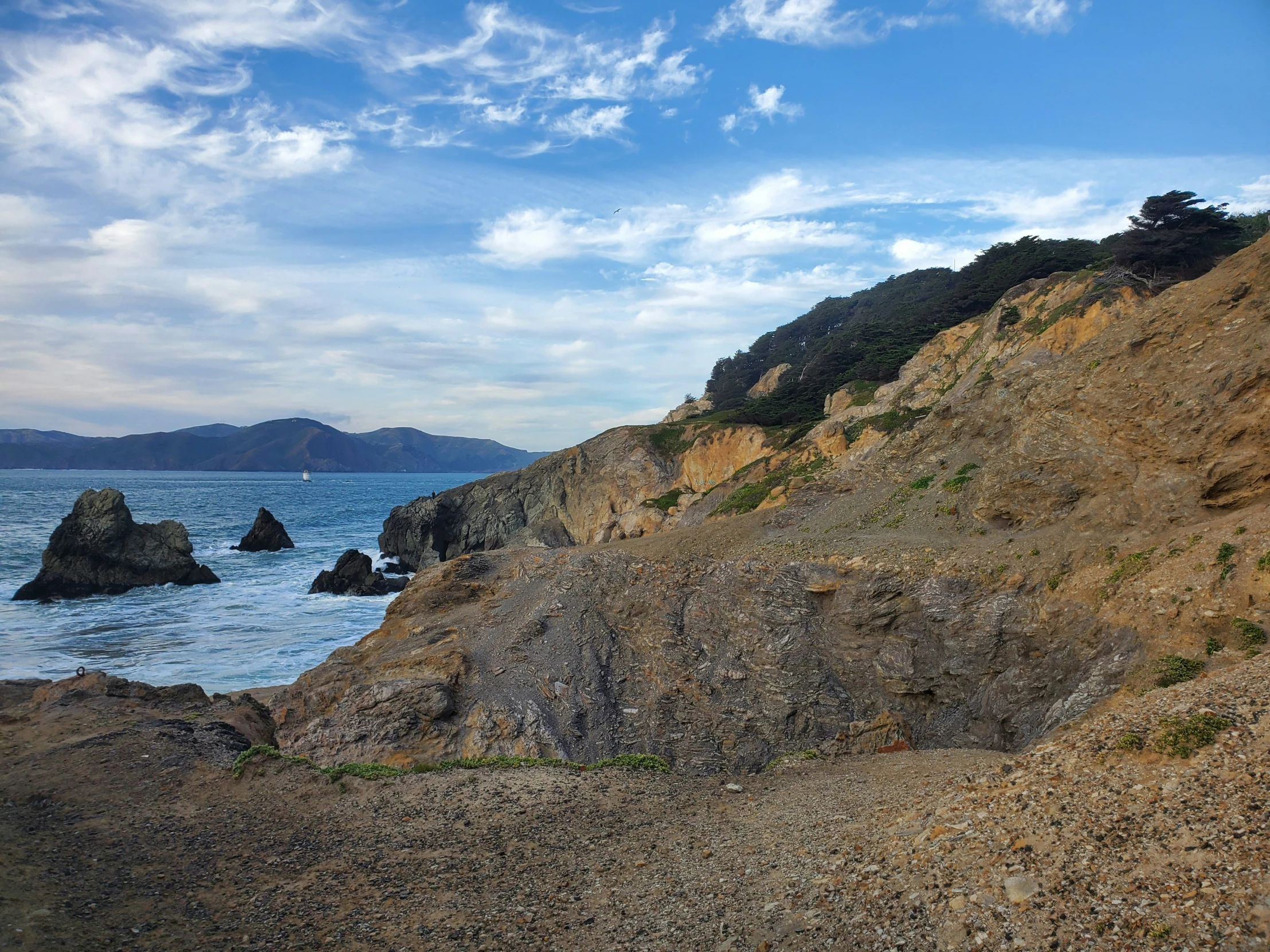 the rocky coastline overlooks an island and the ocean