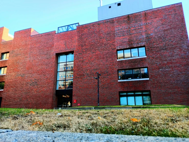 a very big red brick building with lots of windows