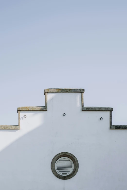 an image of the back side of a building that's white and grey