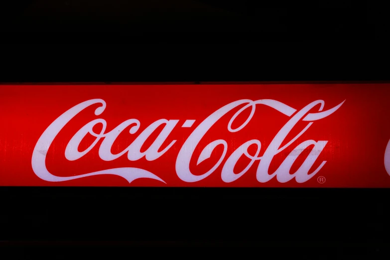 the logo of the coca - cola company is displayed at the company's store