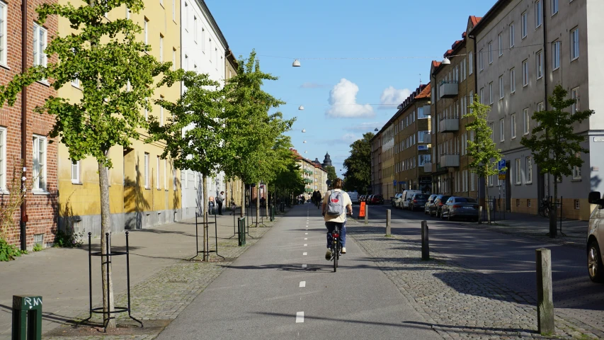 a person riding a bike down the road