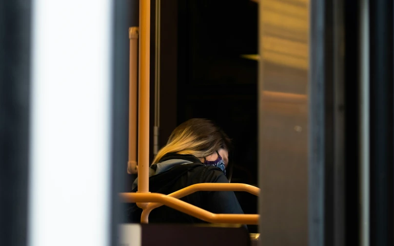 a woman with a cell phone and a coat on