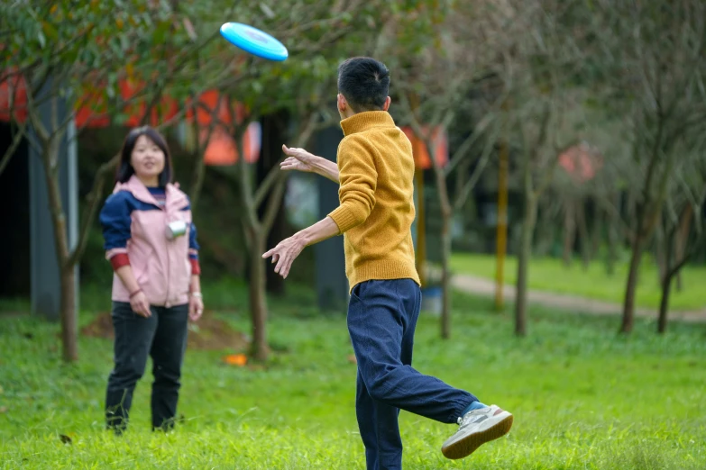 two people playing frisbee in the park together