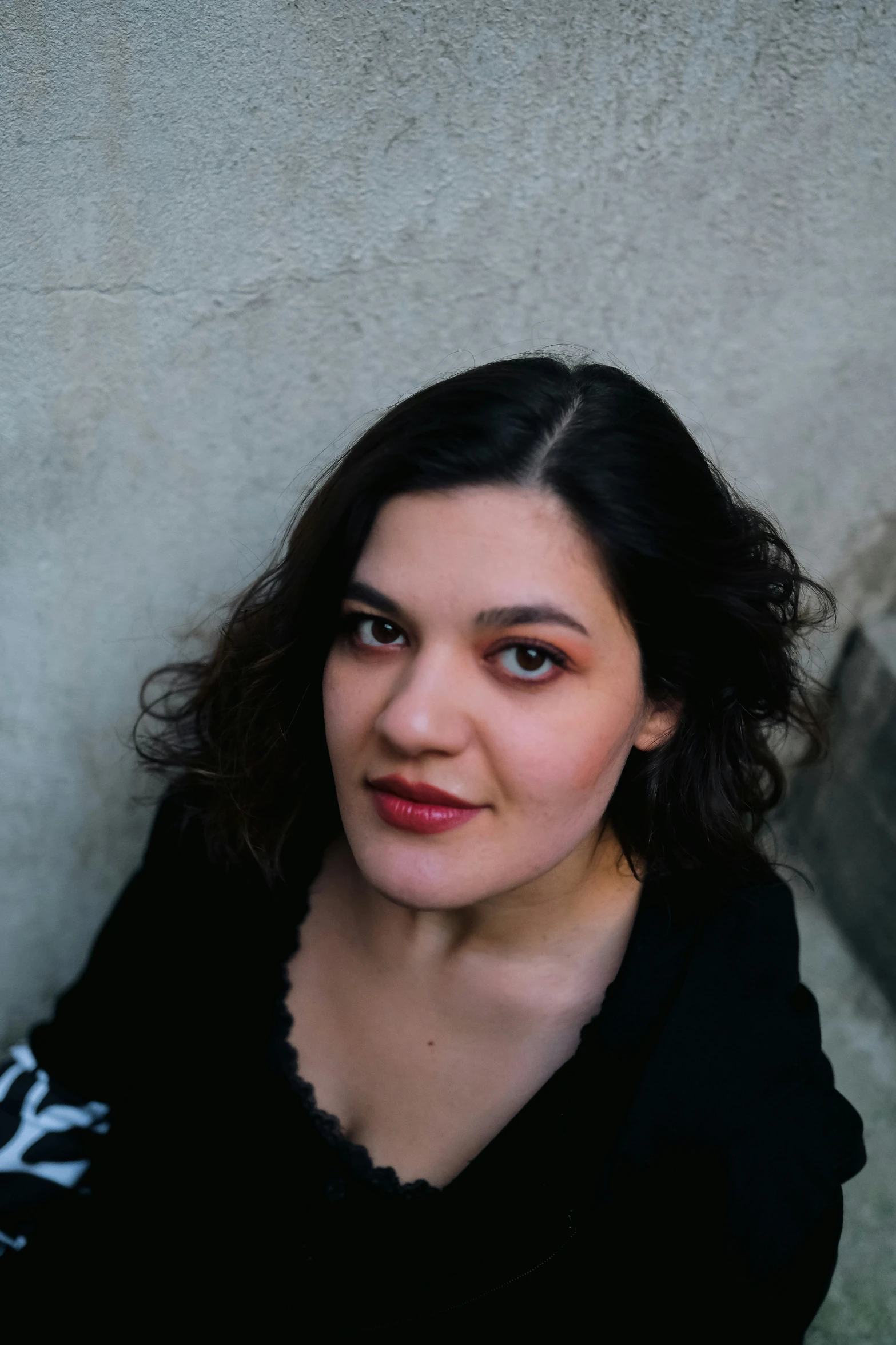 a woman wearing a black shirt and looking to the side