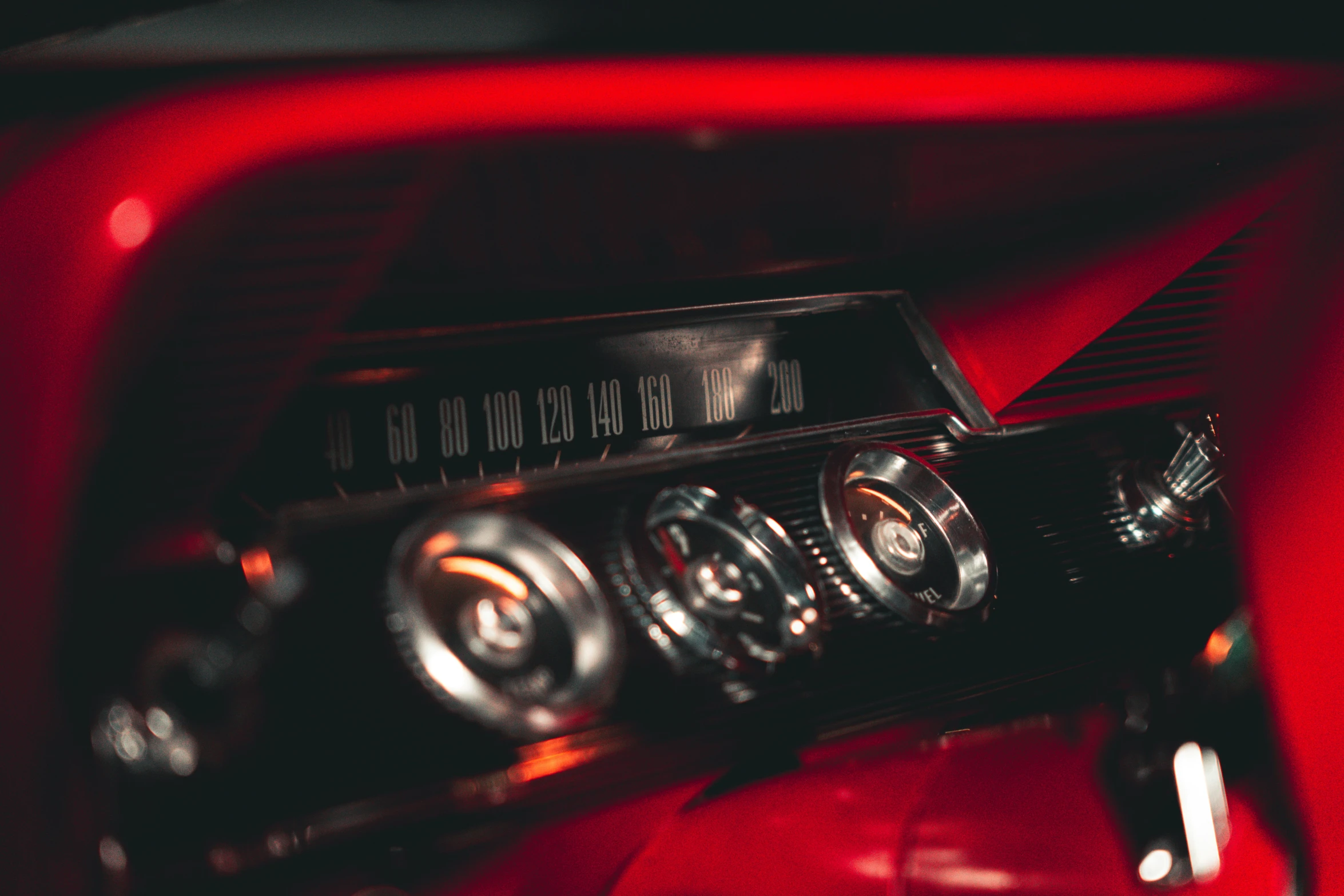 a car with a red dashboard and electronic controls