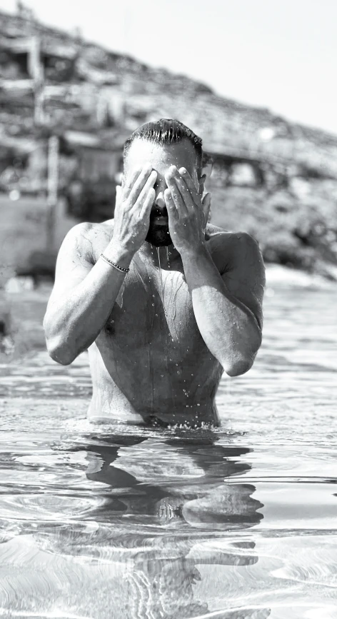 a man is standing in water using his phone