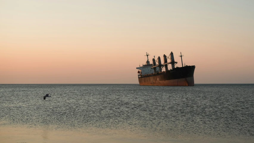 an old boat sailing off the coast of the ocean