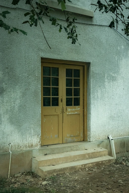 a house with a wooden door on a sunny day