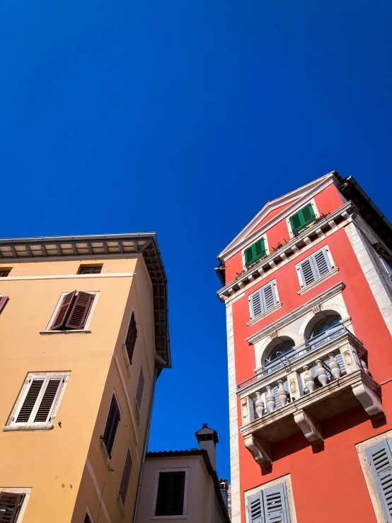 some yellow and red buildings and a white clock