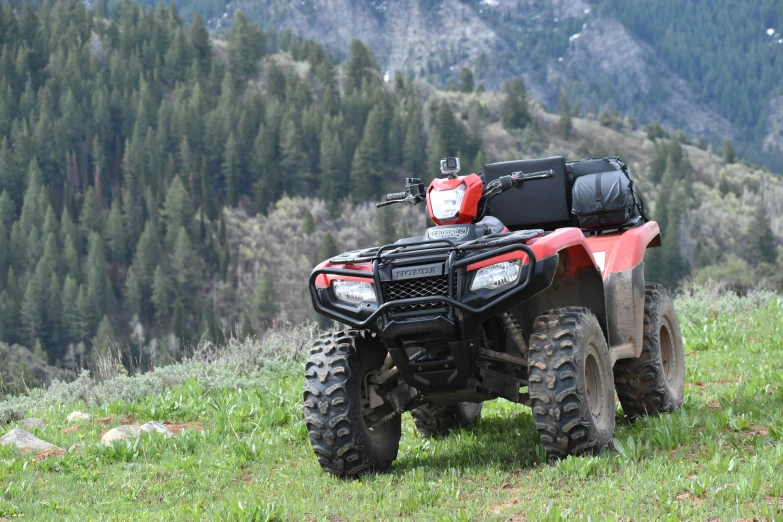 an orange four wheeler parked in the grass