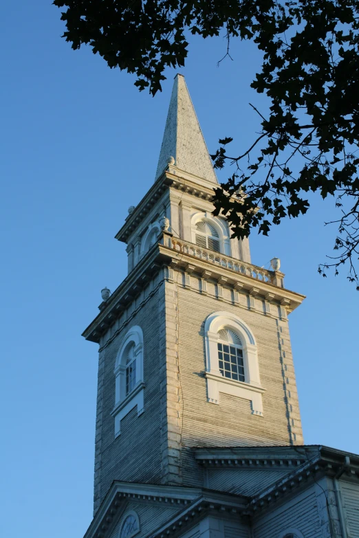 a large brown clock tower sitting above a blue sky
