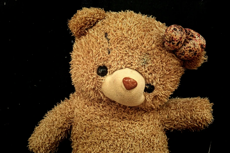 a brown teddy bear holding onto a string