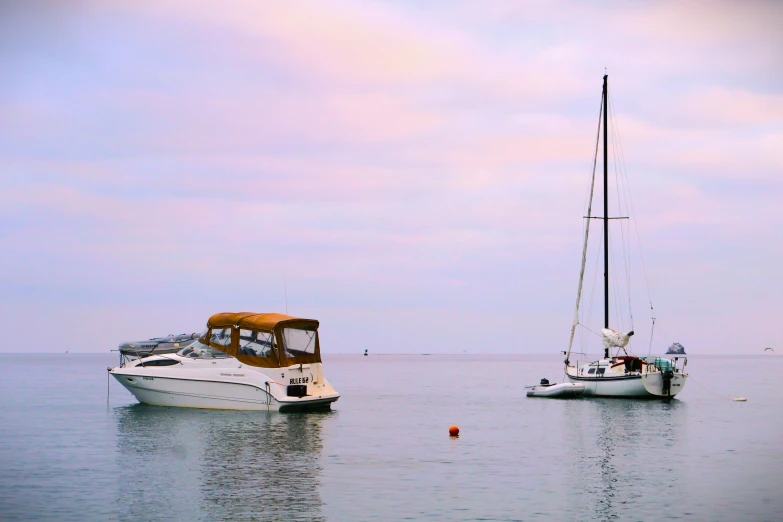 two small boats sitting in the open water